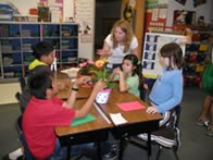 Teacher candidate with students - Science Saturday
