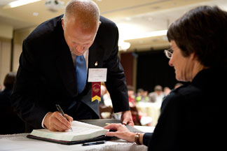 President Leo Lambert signs Phi Beta Kappa membership roll