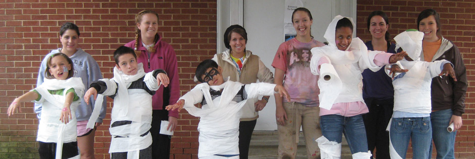 Students in a Qualitative Research Methods class and members of the APO Service Learning fraternity celebrate Halloween 2009 with children at the East Burlington Community Center. Photo credit Kim Jones.