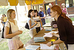 Photo of a staff member assisting an student during orientation.