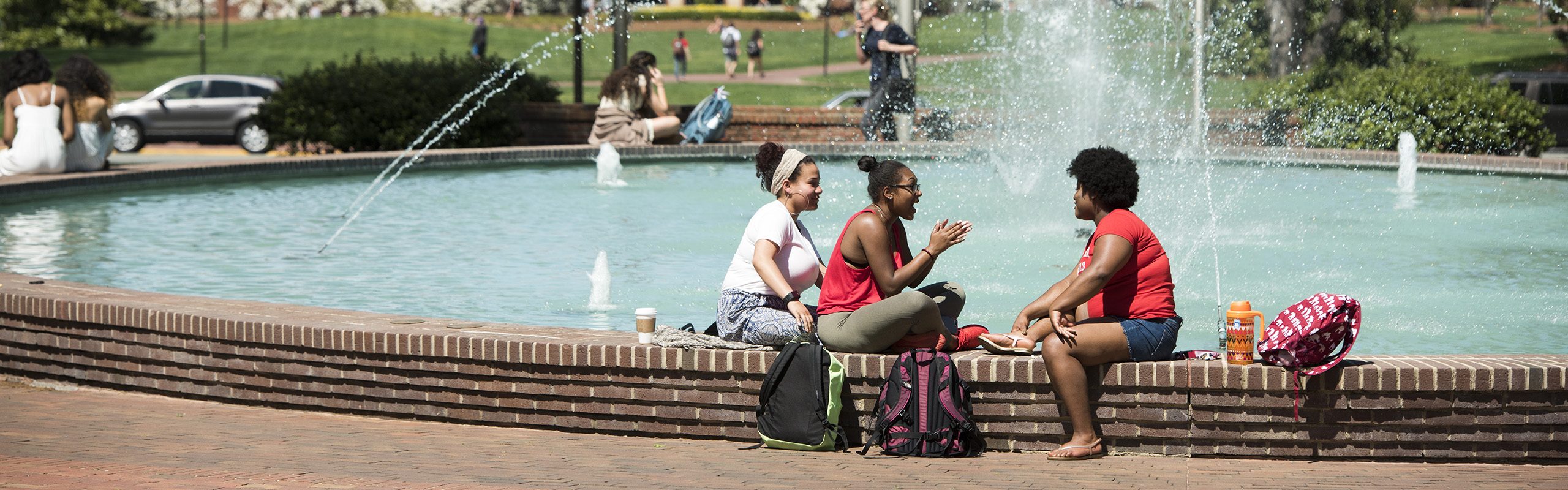 Students sitting by Fonville Fountain.
