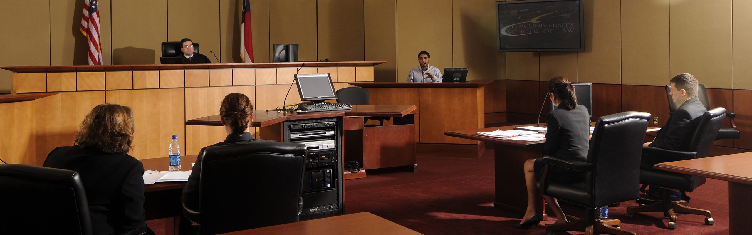 Second-year Elon Law School students participate in a Trial Practice and Procedure final as they argue a case before a local judge in the school's Business courtroom.