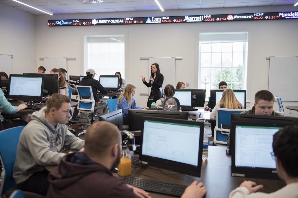 Assistant Professor of Finance Margarita Kaprielyan works with students as she teaches her Financial Modeling With Excel class in the Financial Education Center in Sankey Hall. 