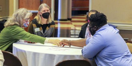 A group of attendees introduce themselves at the Power and Place Collaborative event Dec. 4.